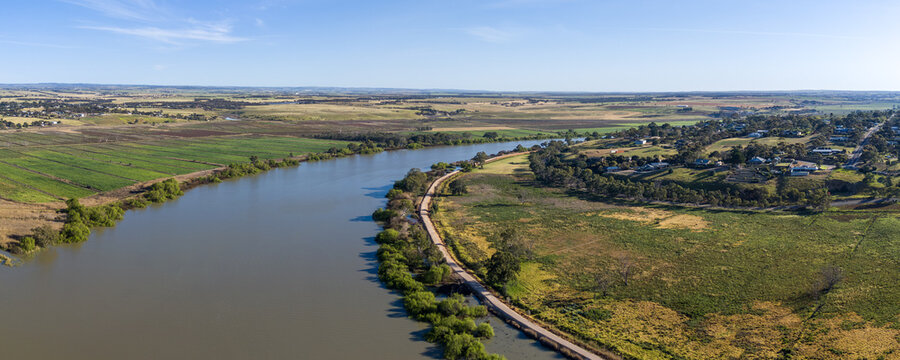 Panoramic aerial drone perspective overlooking the Murray River winding between the agricultural flats of Mobilong and the rural township area of Murray Bridge East in South Australia