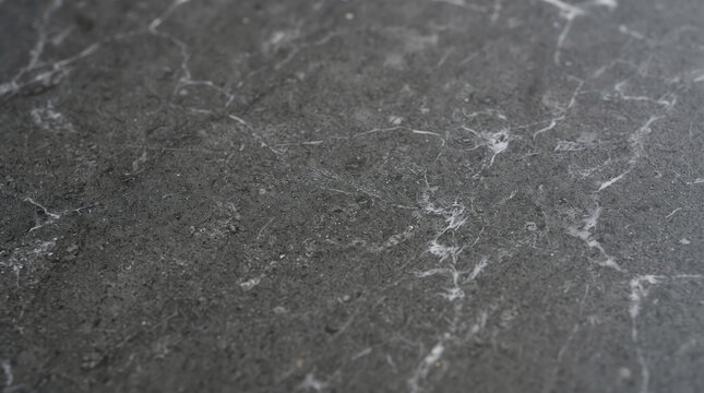 Dark charcoal grey stone texture with white marble veins and copy space