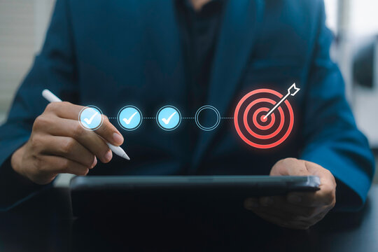 Performance Goal Tracking with business professional using tablet and stylus, digital progress checkpoints and target icon for KPI monitoring, milestone completion and strategic business planning