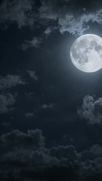 Full Moon Glowing Through Dramatic Clouds - A large, detailed full moon shines brightly from the upper right quadrant of the frame.