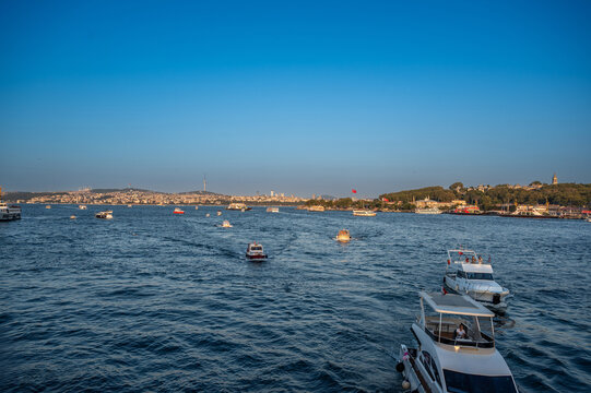 Istanbul,turkey,august 4, 2025. Bosphorus strait in istanbul with boats and ferries cruising past historic waterfront skyline under blue summer sky, panoramic city view