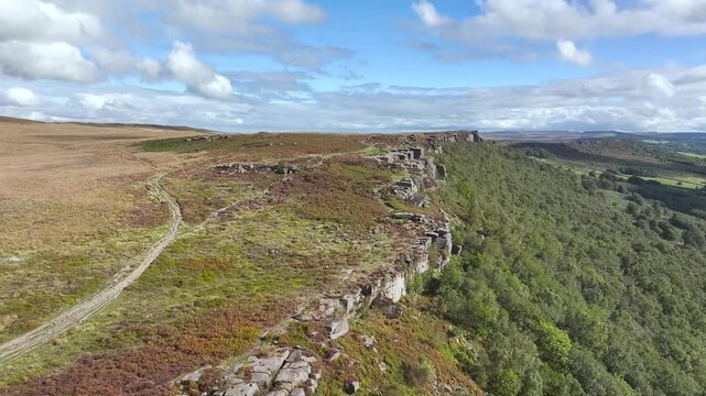 Rocks and Moorland over Curbar Edge and Hope Valley from a drone, Peak District National Park, Curbar, Calver, England, UK