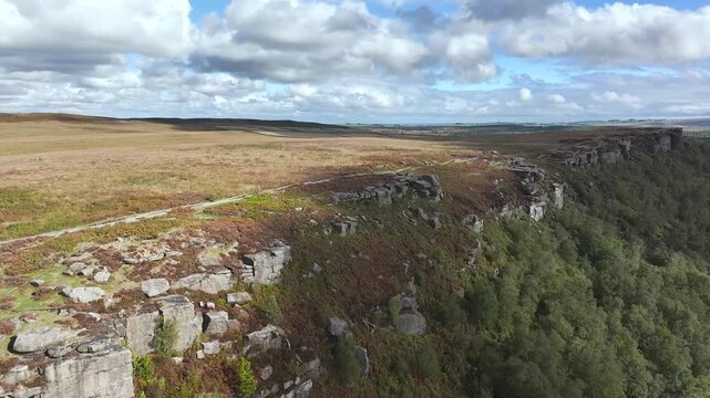 Rocks and Moorland over Curbar Edge and Hope Valley from a drone, Peak District National Park, Curbar, Calver, England, UK