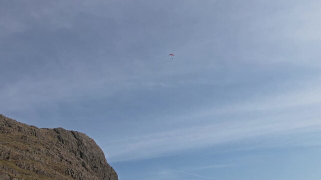 Para glider flying above the Langdales