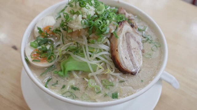 Generous bowl of Japanese ramen with pork and vegetables