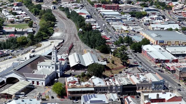 Railway station to historic churches in Ballarat city downtown streets and houses aerial panorama.