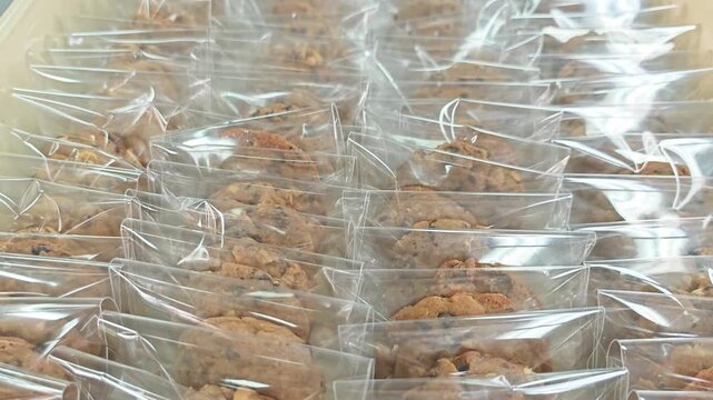 Full frame background of wrapped chocolate chip cookies in rows.