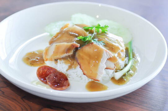 fried pork and rice or rice topped with pork with cucumber and sauce or pork and rice