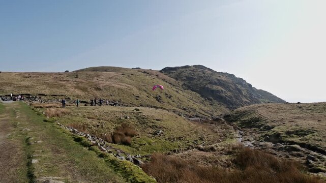 Para glider sweeping down over Stickle tarn to the valley below