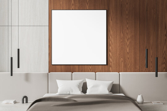 Empty framed poster mockup in modern bedroom interior with wood wall, upholstered bed, pendant lighting, and minimalist design concept. 3D Rendering