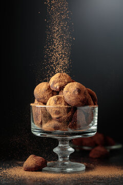 Chocolate truffles sprinkled with cocoa powder.