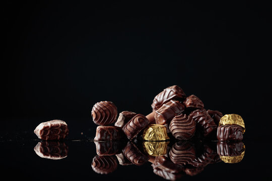 Chocolate candies on a black background.