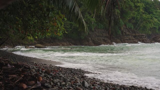 Ocean waves rolling onto a tropical pebble beach, Costa Rica.