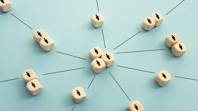 Wooden cubes with people icons over blue background, human resources and management concept