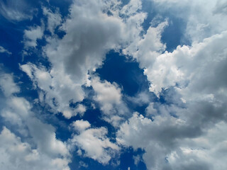 Fototapeta premium Fluffy White Cumulus Clouds in Deep Blue Sky Background.