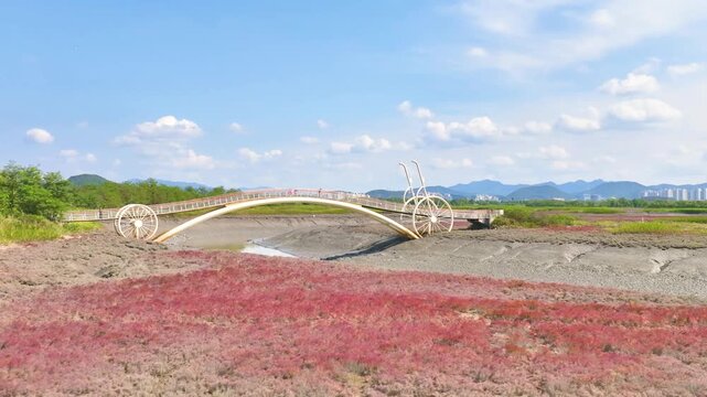 4K slow motion aerial drone shot of Misaeng Bridge over scenic tidal flats in Siheung, South Korea.