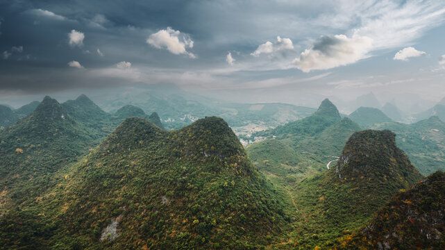 Yangshuo karst limestone mountains layered in green mist and haze atmospheric landscape