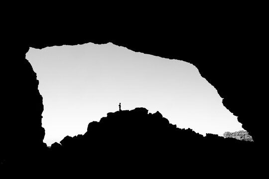 Single person standing in sea cave Gruta das Aguas Belas, Santiago, Cape Verde