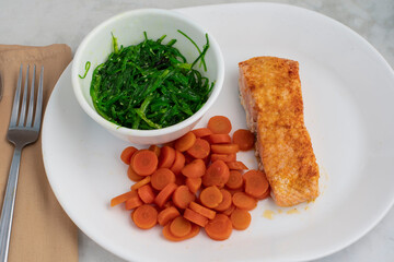 baked salmon  with seaweed salad and carrots © dmiller324