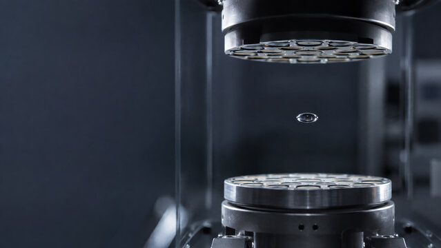 Industrial machine performing precision compression or material test in laboratory, quality control, engineering research, manufacturing and technical analysis.