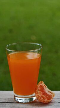 Fresh orange juice in a glass under natural sunlight	