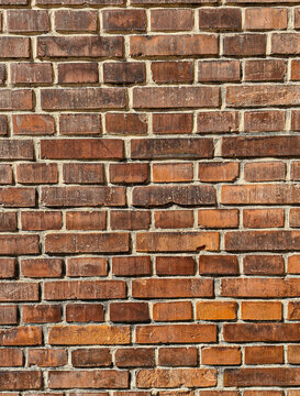 Dark red brown brick wall texture background close-up, weathered industrial masonry pattern with copy space