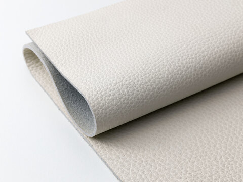 Folded Off-White Genuine Leather Hide Showing Suede Backing on White Background