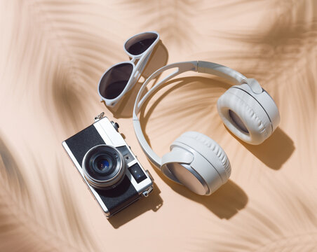 Retro Camera, Headphones and Sunglasses with Tropical Palm Shadow