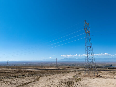 high voltage transmission tower and power lines under blue sky