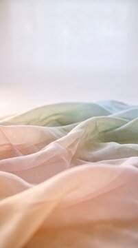Flowing pastel silk fabric layers forming soft dunes, representing fluidity and gentle calm