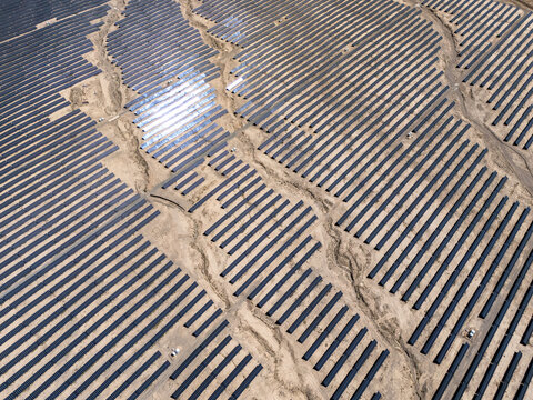 Rows of solar panels in the desert generating clean energy