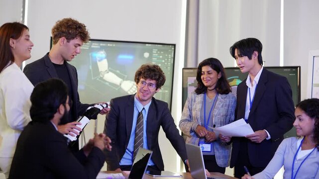 Smiling engineer in suit and tie leans on the meeting table as colleagues holding a bionic hand and reports discuss the project, while ideas are exchanged, a modern AI business scene