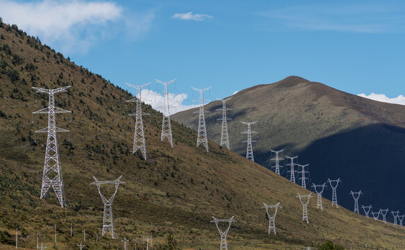 Countryside mountain hills landscape, with electricity and telecommunication towers industrial technology