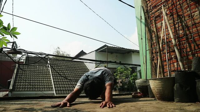 Child crawling on a rooftop in an urban environment during daytime.