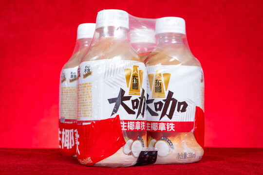ZhongShan GuangDong China-September 18 2026: Dongpeng Daka raw coconut latte drink four bottle pack wrapped with plastic film.