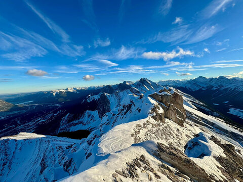 Snowy mountain ridge and panoramic summit views from Mount Lawrence Grassi near Canmore, Alberta, Canada