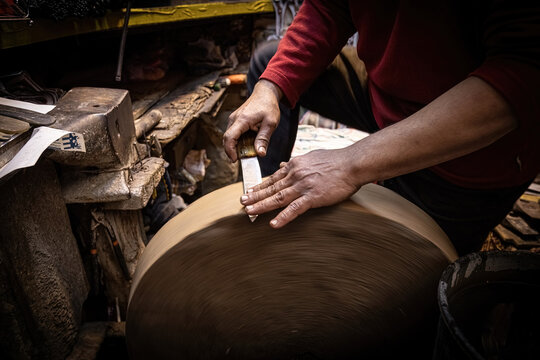 Man sharpening the knife with traditional stone wheel sharperner on the market in old Medina in Fes, Morocco
