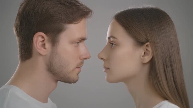 Couple's Profiles Facing Each Other in Sequential Frames During Soft Studio Lighting