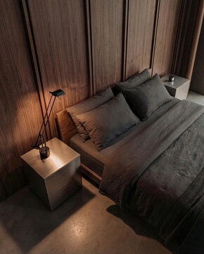 Modern bedroom interior with dark linen bedding a wood panel headboard and warm evening light