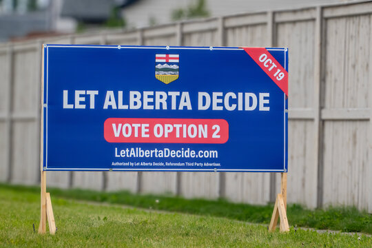 Calgary, Alberta, Canada. September 27, 2026. Let Alberta Decide political referendum lawn sign posted on grass against a wooden fence.