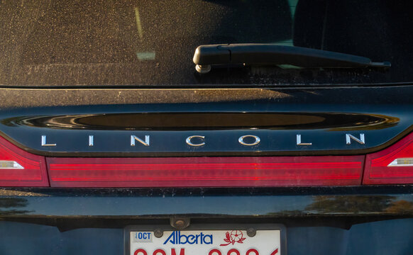 Calgary, Alberta, Canada. September 27, 2026. Close-up of a black Lincoln luxury car rear badge, tail light, and Alberta license plate.
