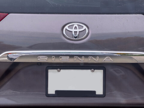Calgary, Alberta, Canada. September 27, 2026. Close-up of a Toyota Sienna minivan rear emblem, chrome nameplate, and blank license plate.