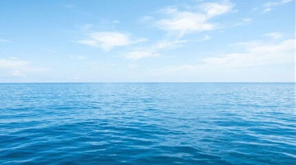 Naklejka premium Vast ocean meets sky in perfect harmony. Blue waves ripple gently under soft light. Thin clouds drift lazily across the horizon. Calmness radiates from the endless sea