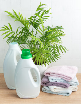 Laundry cleaning products with folded towels and plant