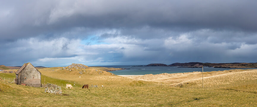 Dark storm clouds above coastal grass and sea at Uig, Isle of Lewis