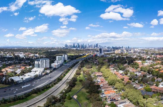 Aerial panorama of the Melbourne city skyline over the busy Tullamarine Freeway in Ascot Vale