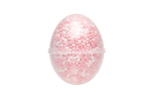 Transparent plastic egg capsule filled with small pink and white foam beads, isolated on a clean white background