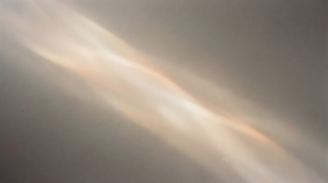 Soft cream and golden light leak spreading diagonally across a neutral background, creating an elegant warm abstract visual effect.