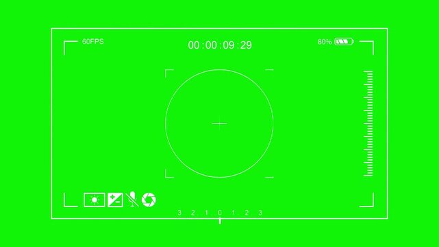 Camera viewfinder places a circular focus reticle in the center, with corner guides and status controls surrounding a wide green recording screen. Built for recording graphics and postproduction.