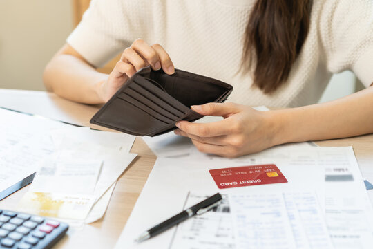 Debt financial concept, stressed problem asian woman hand open empty wallet, purse not have budget of money to pay no have credit card, not able payment bill, loan or expense with bank, bankruptcy.